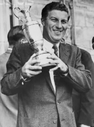 Peter Thomson holds up the British Open trophy.