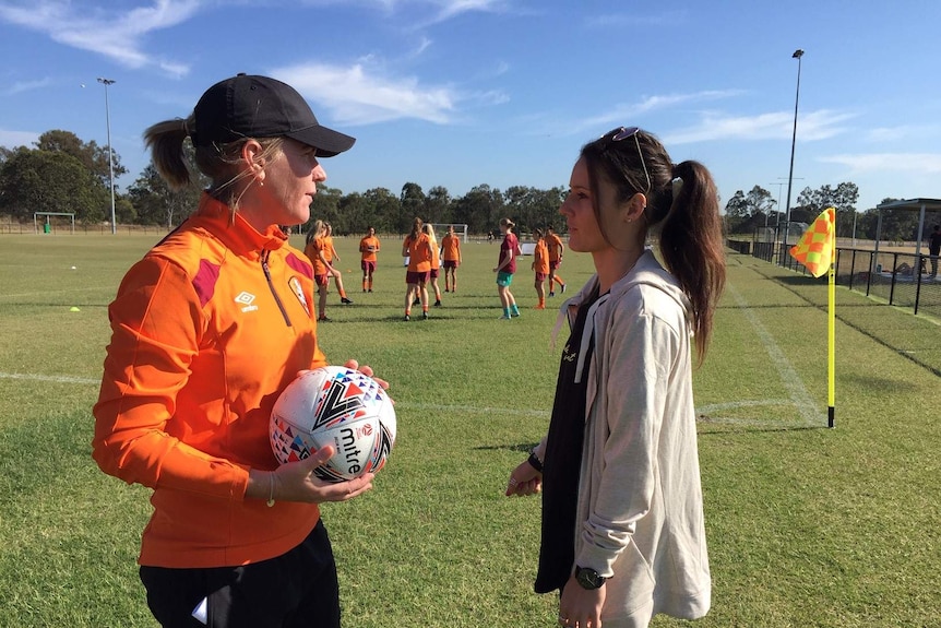 After breaking her back playing in the US, Hayley Raso makes an emotional return to watch Brisbane Roar pre-season training.