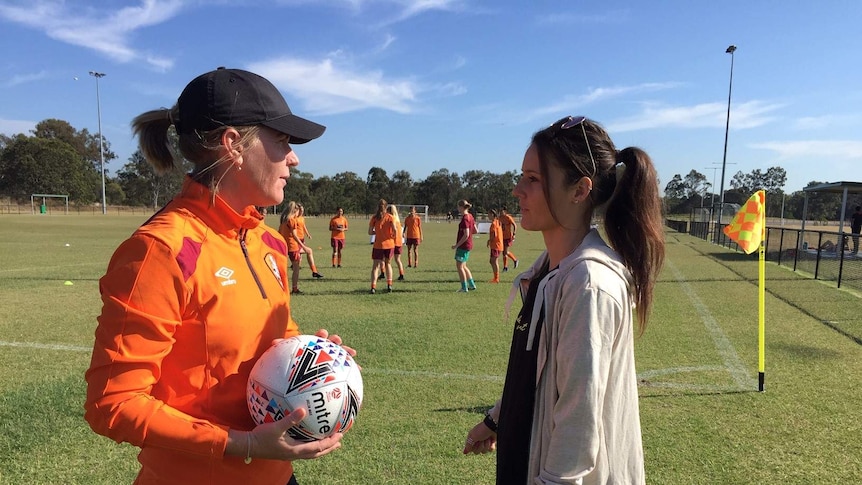 After breaking her back playing in the US, Hayley Raso makes an emotional return to watch Brisbane Roar pre-season training.