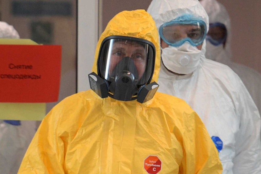 Vladimir Putin wearing a yellow hazmat suit including breathing apparatus