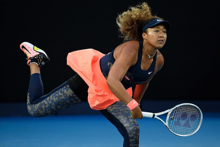 Naomi Osaka serves to Jennifer Brady in the Australian Open final in Melbourne.