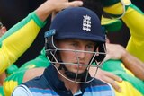 England batsman Joe Root walks past celebrating Australians during their Cricket World Cup match at Lord's.