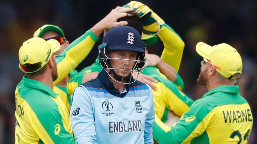 England batsman Joe Root walks past celebrating Australians during their Cricket World Cup match at Lord's.