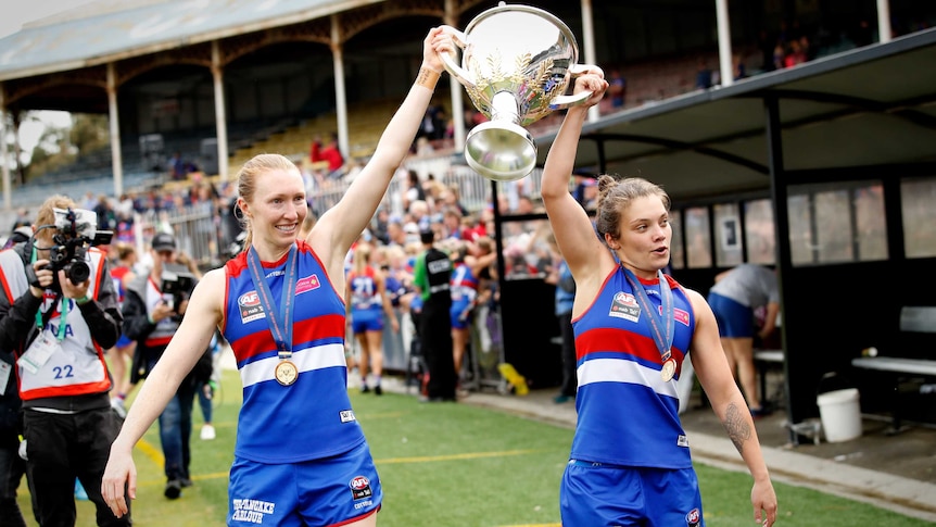 Two female footballers celebrate success