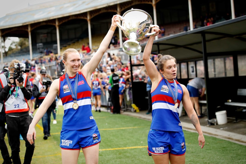 Two female footballers celebrate success