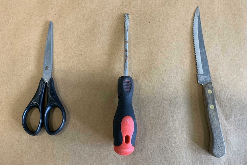 Scissors, a screwdriver and a knife found in bushland near where prison escapee Graham Enniss was recaptured.