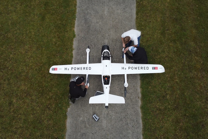 Aerial view of people preparing a hydrogen powered drone for its first flight