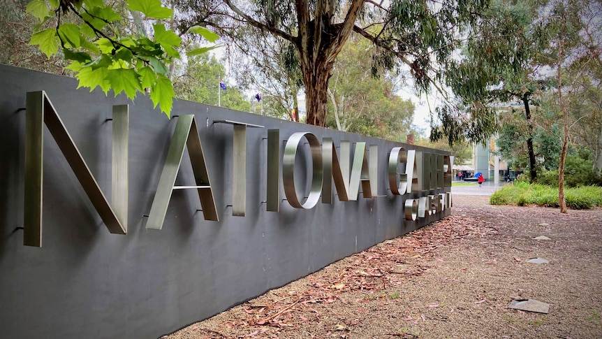 A large concrete sign with letters saying National Gallery of Australia.