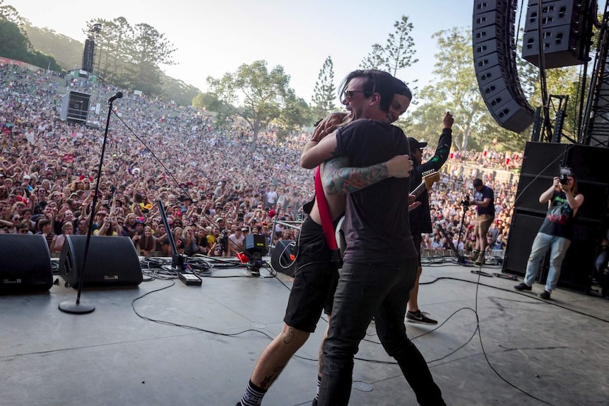 Danny from Dune Rats hugging Grinspoon's Phil Jamieson on stage at Splendour 2017