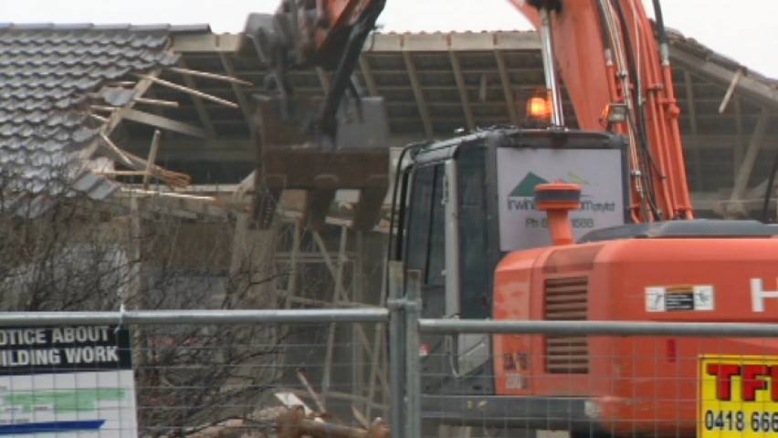 A former Mr Fluffy asbestos insulation house being demolished in Canberra in July.