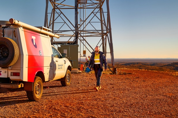 A worker near a phone tower in the outback.