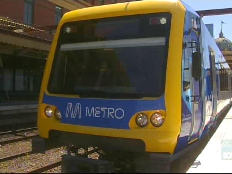 A train with Metro signage at a railway station.