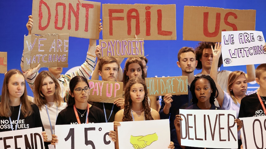 Young climate activists hold signs saying 'Don't fail us' at the COP27 climate summit.