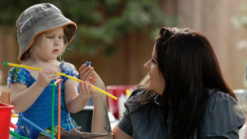 Childcare director Emma Lewis engages a child