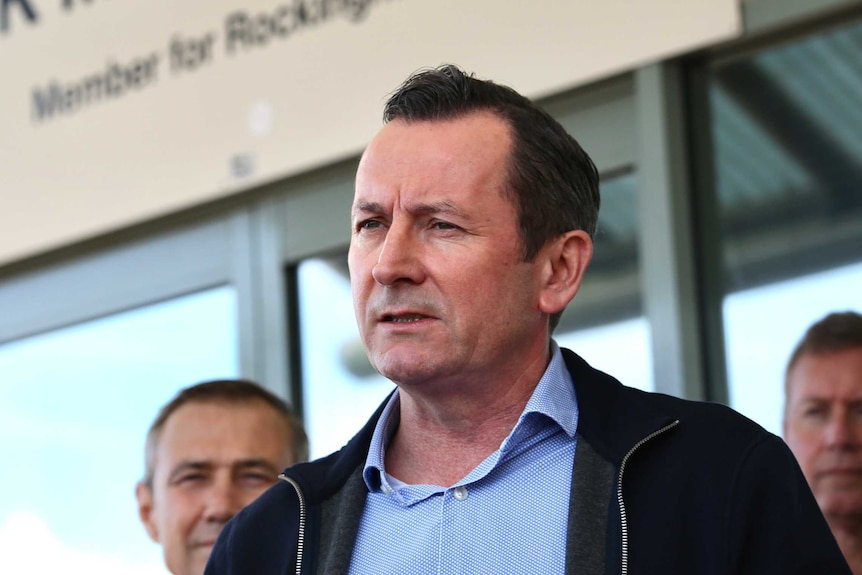 WA Premier Mark McGowan speaks outside of his Rockingham office wearing a shirt and casual jacket.