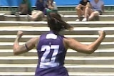 Fremantle Dockers AFLW player Gemma Houghton runs away in celebration.
