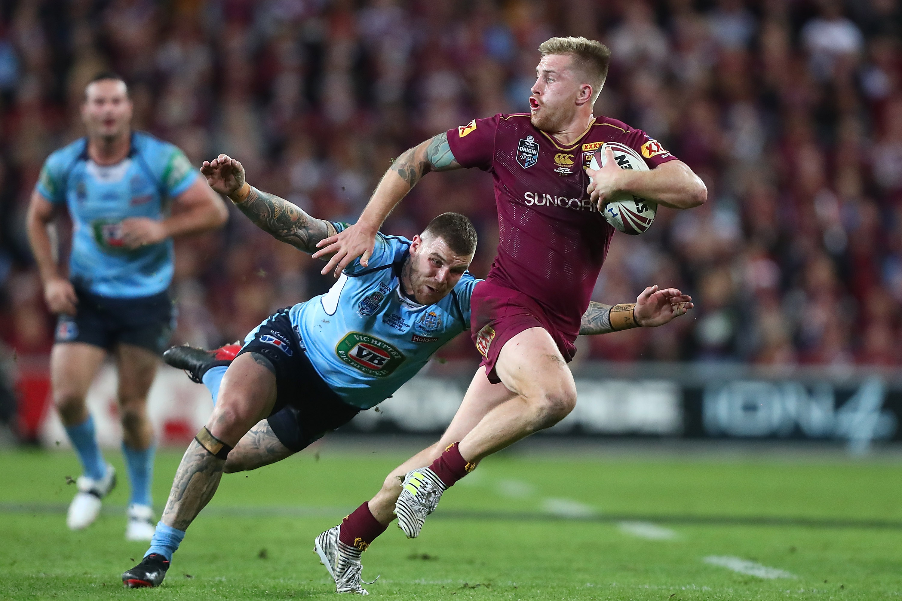 A man runs the ball during a rugby league match 