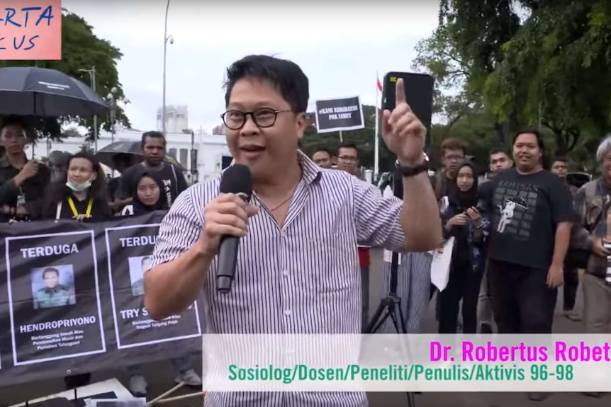 A man gestures as he gives a speech in front of the presidential palace in Jakarta.