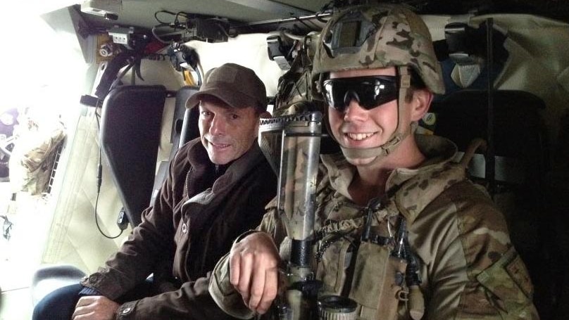 Tony Abbott poses for a photo with an Australian troop inside a Bushmaster in Afghanistan.