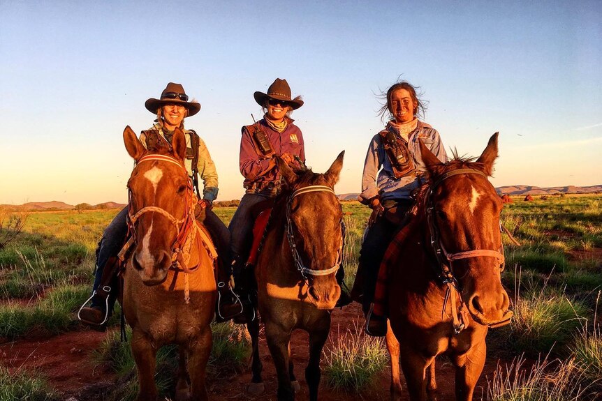 Three young women sitting on horseback in the outback