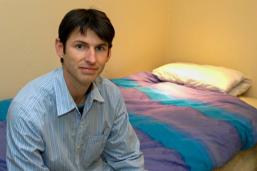 Dr Michael Gradisar sits on a bed at the Adelaide Institute for Sleep Health.