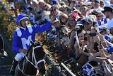 Hugh Bowman celebrates atop Winx after winning Turnbull Stakes