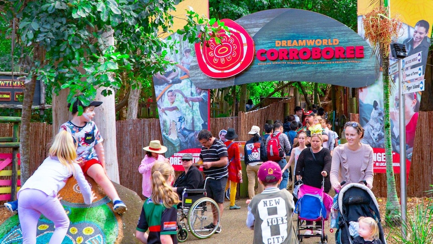 Visitors to Dreamworld theme park walking in and out of the entrance to the Indigenous stories attraction