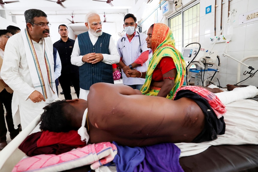 Narendra Modi meets with the victims of trains collision at a hospital.