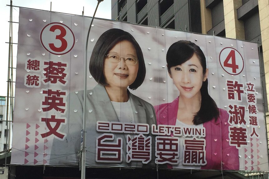 Tsai Ing-wen and another candidate a sprawled across the side of a large building with the message '2020 let's win'