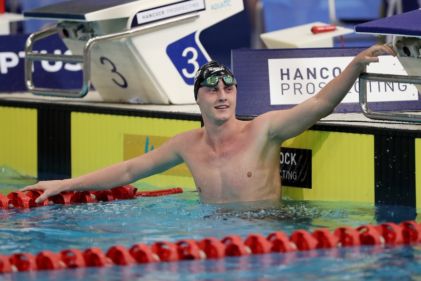 Elijah Winnington, wearing a swimming cap and goggles, in the pool after winning the 400 metres freestyle final.