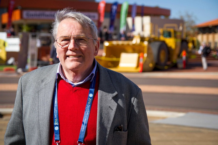 Head and shoulders shot of Tim Treadgold, taken outside with mining machinery in the background.