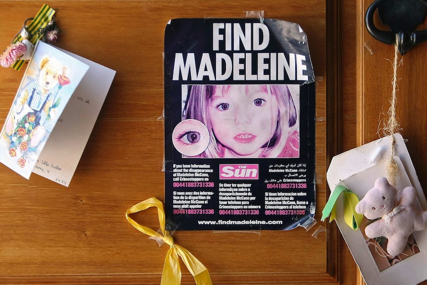 A poster with 'Find Madeleine' on it taped to a door with greeting cards and teddy bears stuck near it