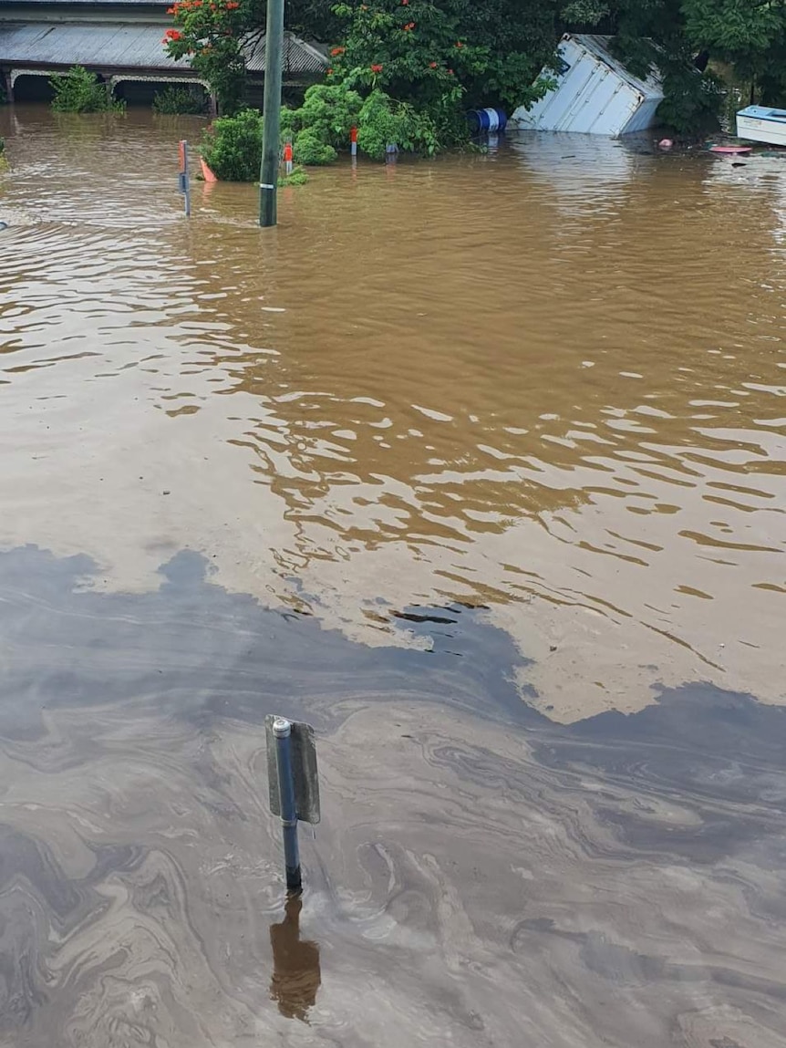 An oil slick in brown floodwaters in Broadwater New South Wales.