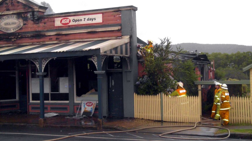 Firefighters tend to the scene in Jamberoo after fire gutted the IGA store.