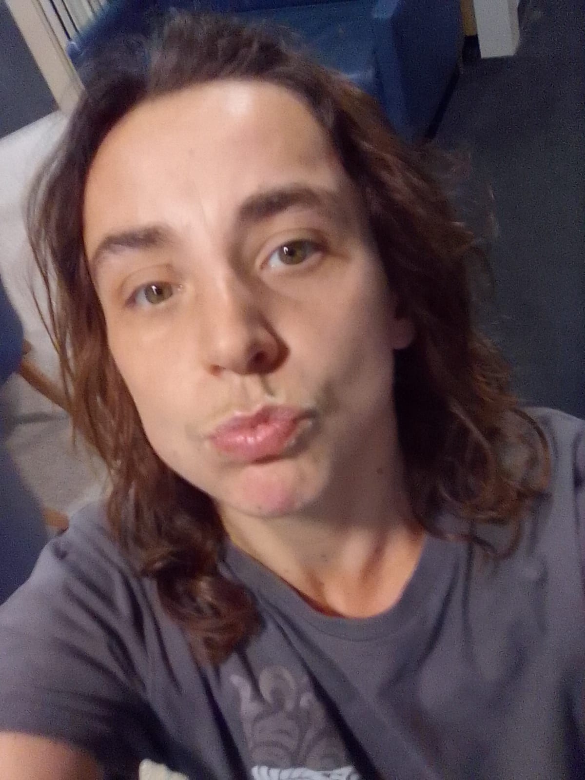 A slightly blurry photo of a woman pouting at the camera.