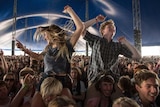 Two young people dance in a large Splendour in the Grass crowd from 2013