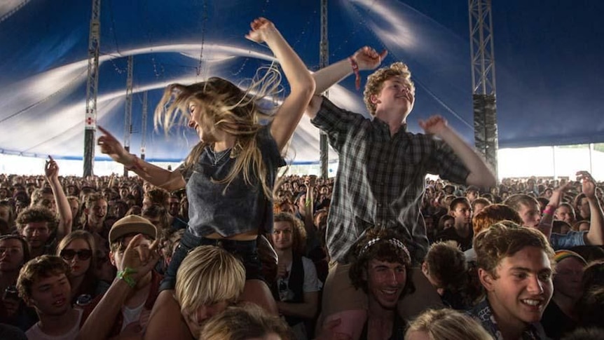 Two young people dance in a large Splendour in the Grass crowd from 2013