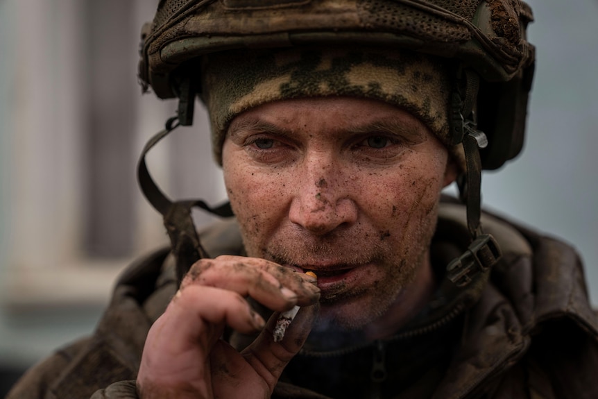 A Ukrainian serviceman who recently returned from the trenches of Bakhmut smokes a cigarette.