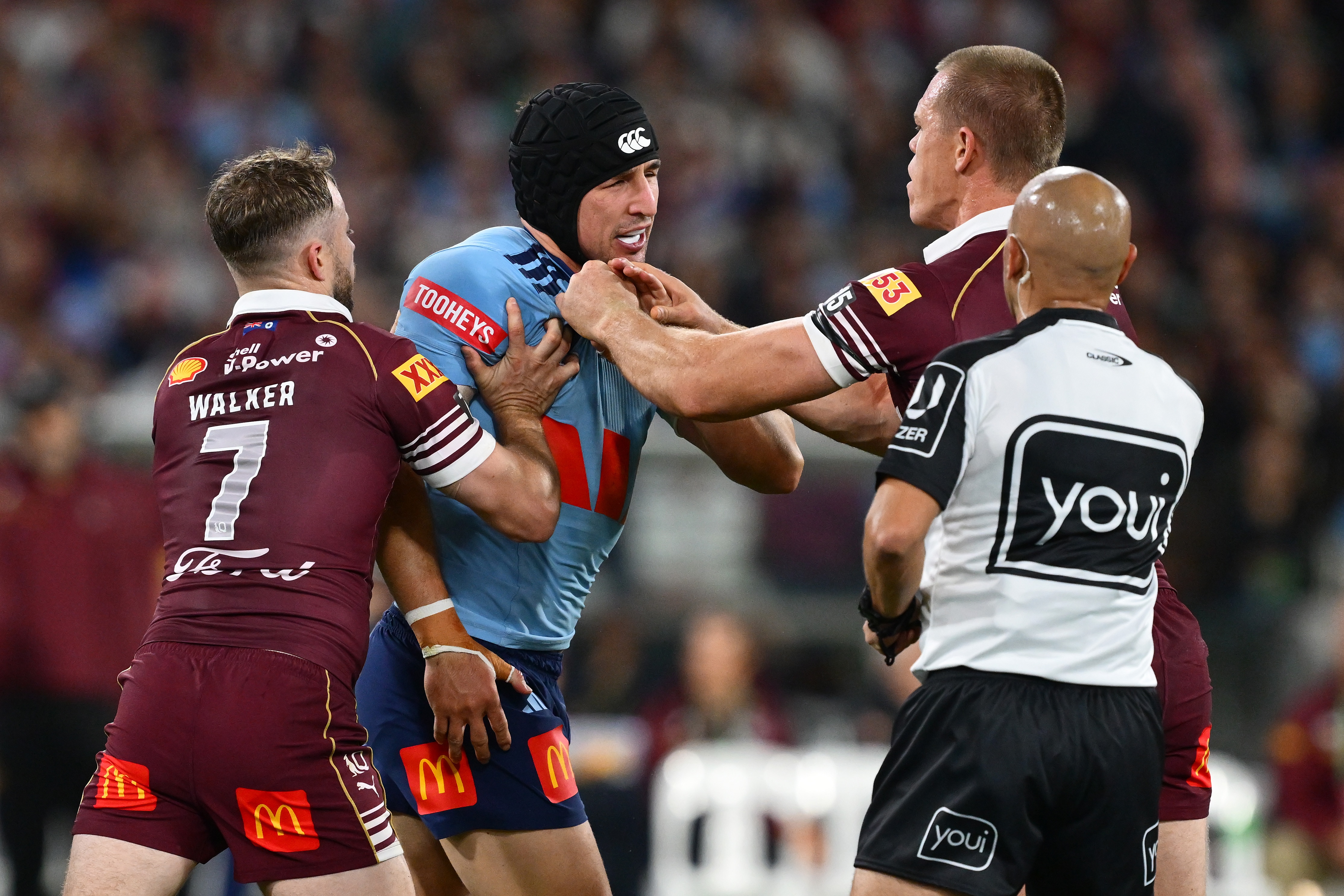 Victor Radley is accosted by Queensland players in State of Origin II.