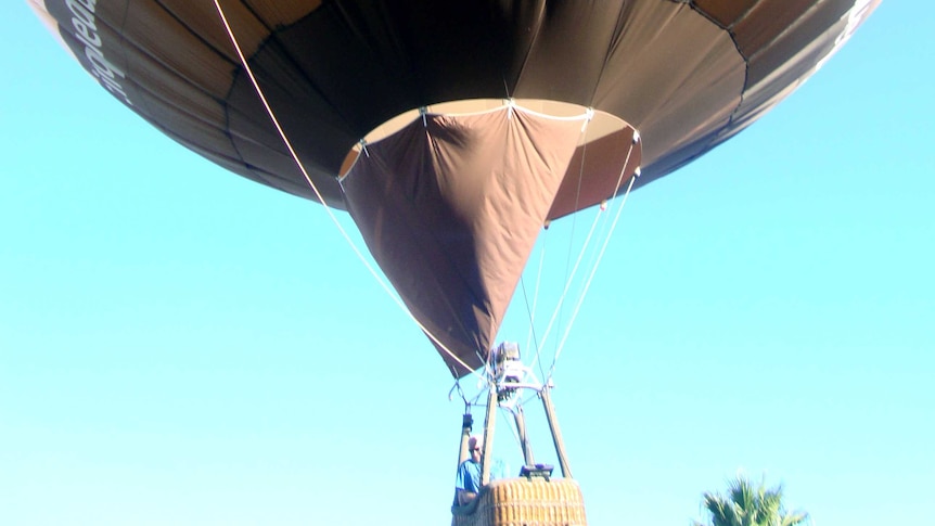 The hot air balloon as it comes in to make an emergency landing