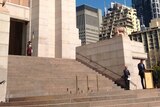 NSW Premier Mike Baird on the steps of Sydney's Hyde Park Anzac Memorial.