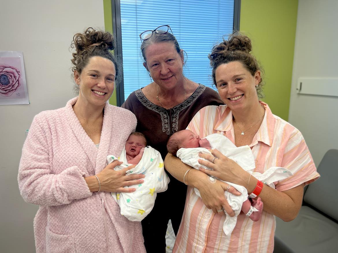 Twin women with babies and mother