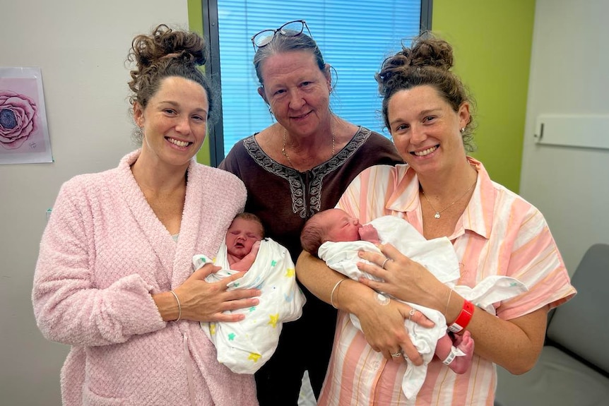 Twin women with babies and mother
