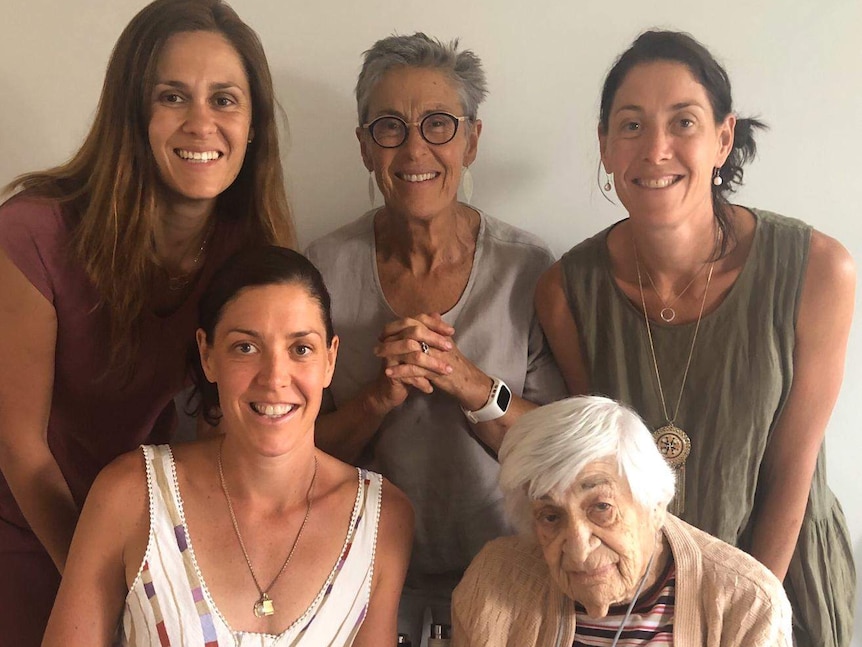 Five women standing together and smiling