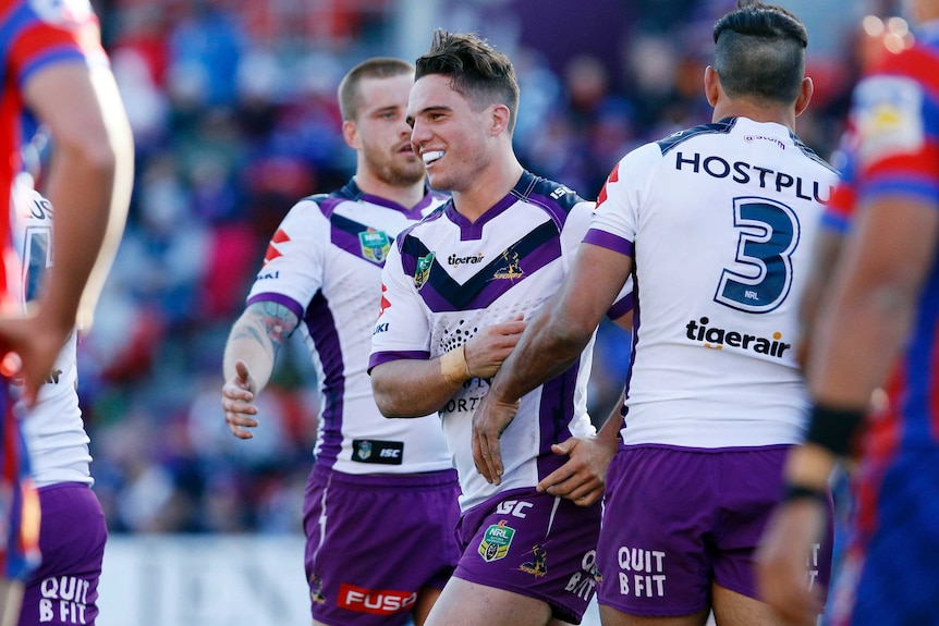 Brodie Croft of the Storm celebrates after scoring a try against Newcastle