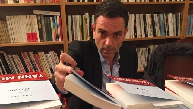 French author Yann Moix signs books.