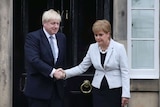 Scotland's First Minister Nicola Sturgeon shakes hands with Boris Johnson outside Bute House in Edinburgh, Scotland.