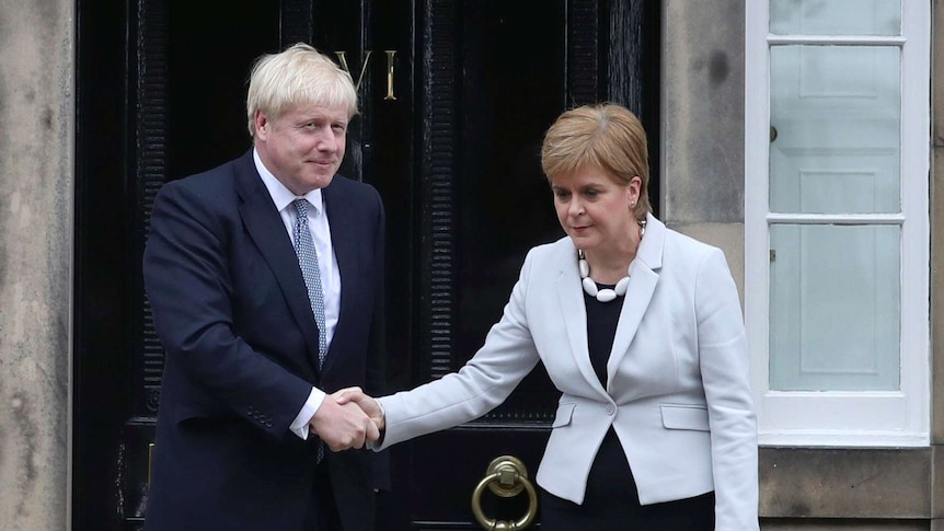 Scotland's First Minister Nicola Sturgeon shakes hands with Boris Johnson outside Bute House in Edinburgh, Scotland.