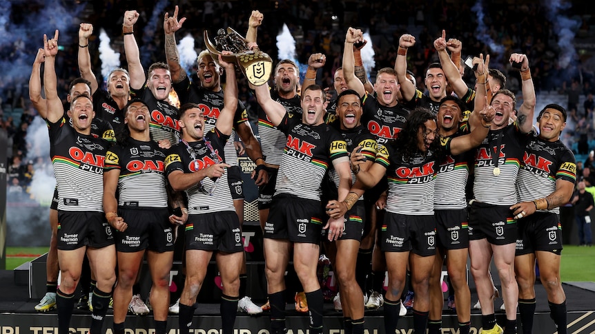 The Penrith Panthers celebrate with the NRL premiership trophy.