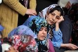 Relatives mourn a Turkish victim of blast near Syrian border